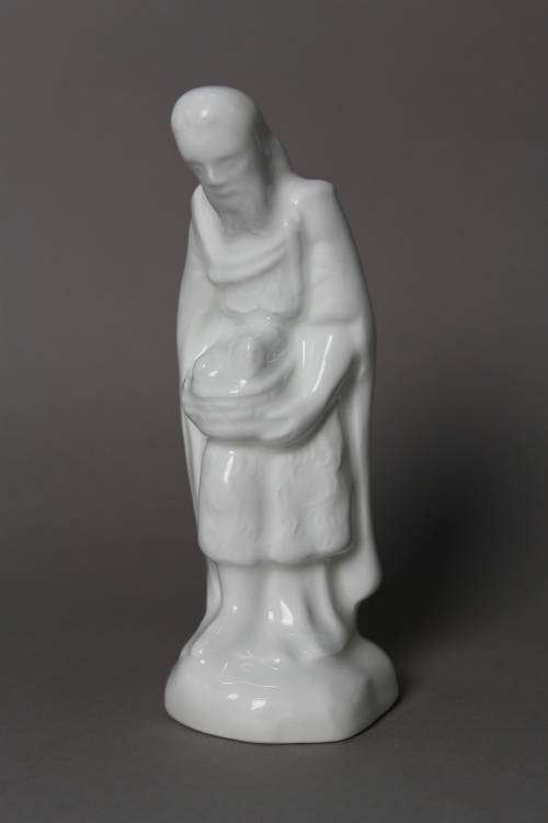 Baker. Small, white glazed figure.