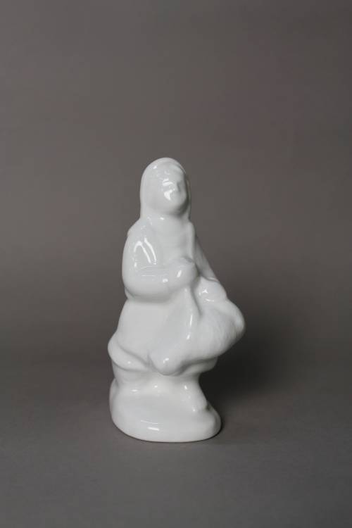 Shepherdess with sheep. Small, white glazed figure.