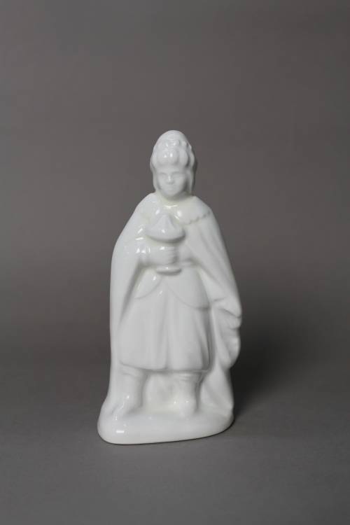 Wise man carrying myrrh and wearing a turban with pearls. Small, white glazed figure.