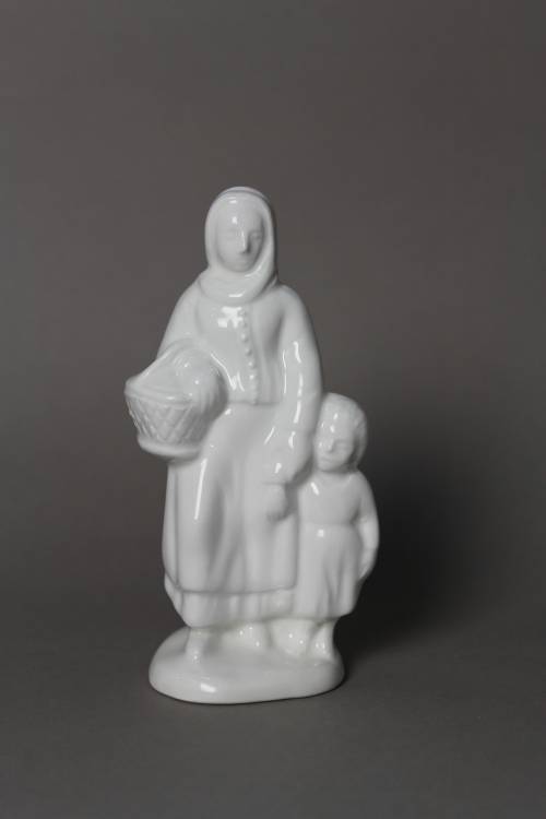 <p>Woman with child and basket. Small, white glazed figure.</p>